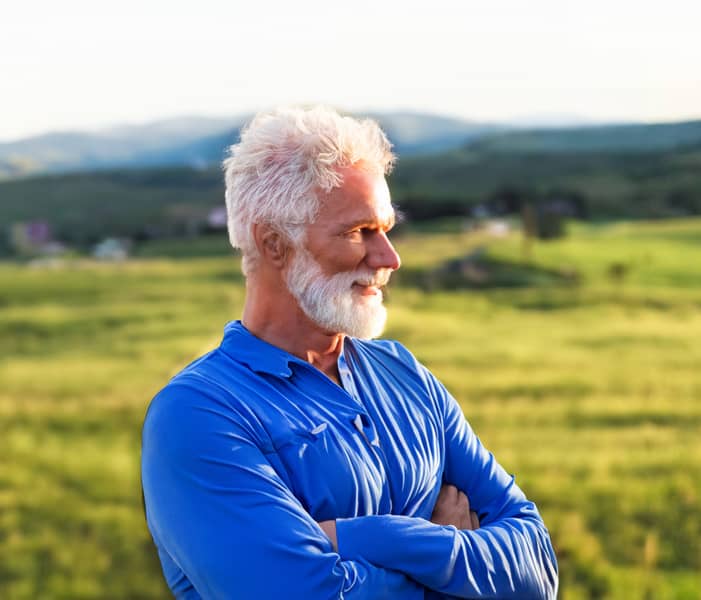 A handsome senior man looks with satisfaction over the medical care he receives through PromiseCare